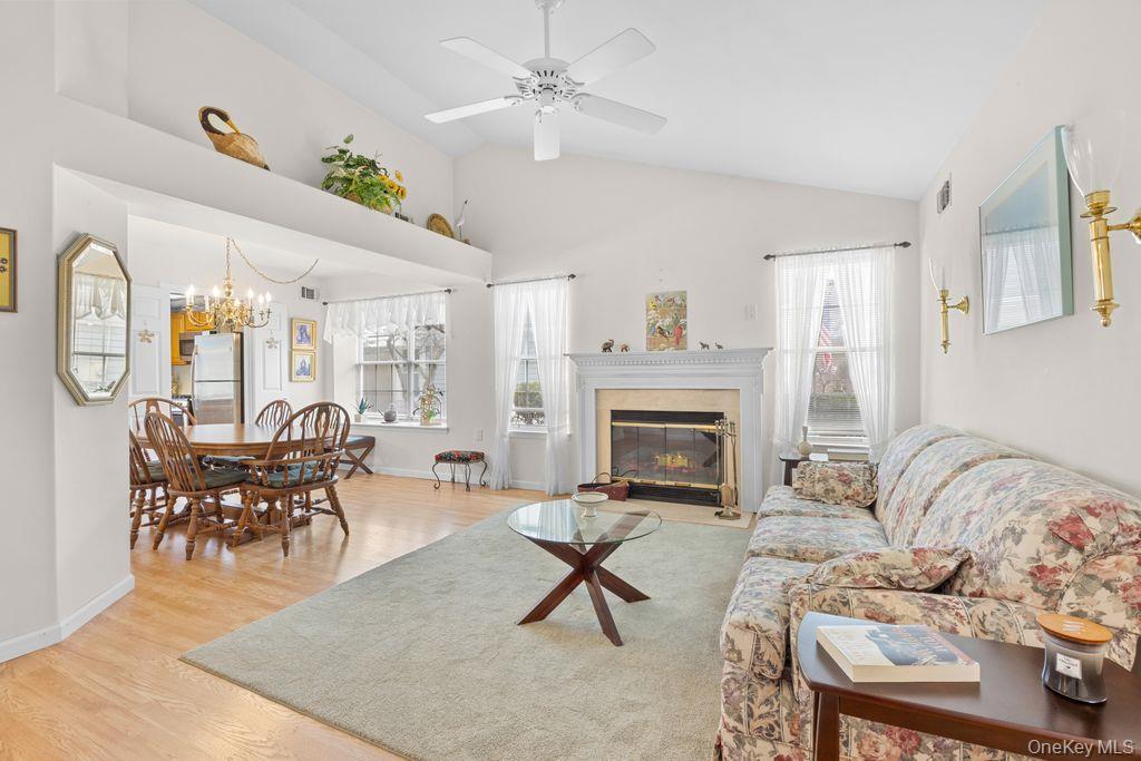 16 Huntington Court Ridge, NY 11961 - Photo 8 of 43 a living room with furniture a fireplace and a table