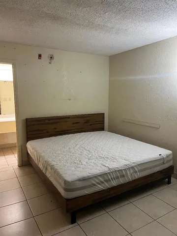 a bathroom with a granite countertop sink a toilet and a mirror