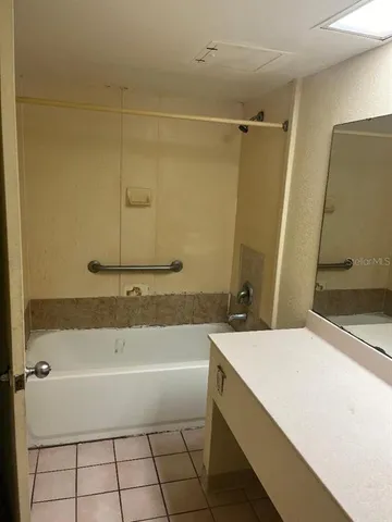 a white toilet sitting next to a shower