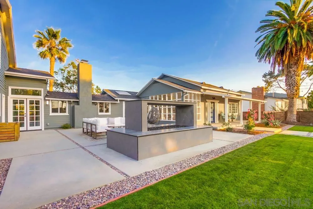 a view of a house with a swimming pool and a yard