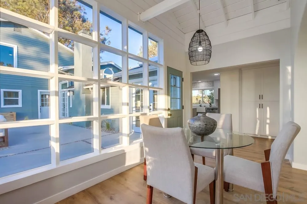 545 Ocean View Avenue Encinitas, CA 92024 - Photo 19 of 75 a dining room with furniture a chandelier and wooden floor