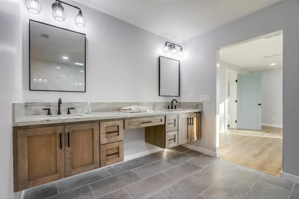 545 Ocean View Avenue Encinitas, CA 92024 - Photo 39 of 75 a bathroom with a sink vanity and mirror