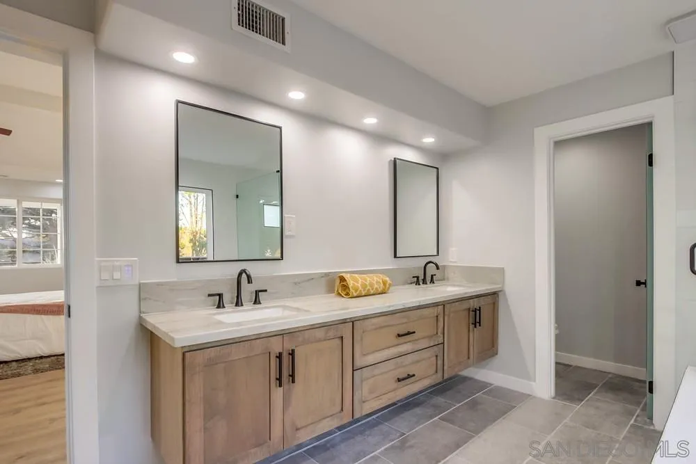 545 Ocean View Avenue Encinitas, CA 92024 - Photo 50 of 75 a bathroom with 2 sink tub and a mirror