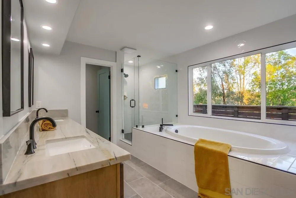 545 Ocean View Avenue Encinitas, CA 92024 - Photo 51 of 75 a bathroom with a tub sink and mirror