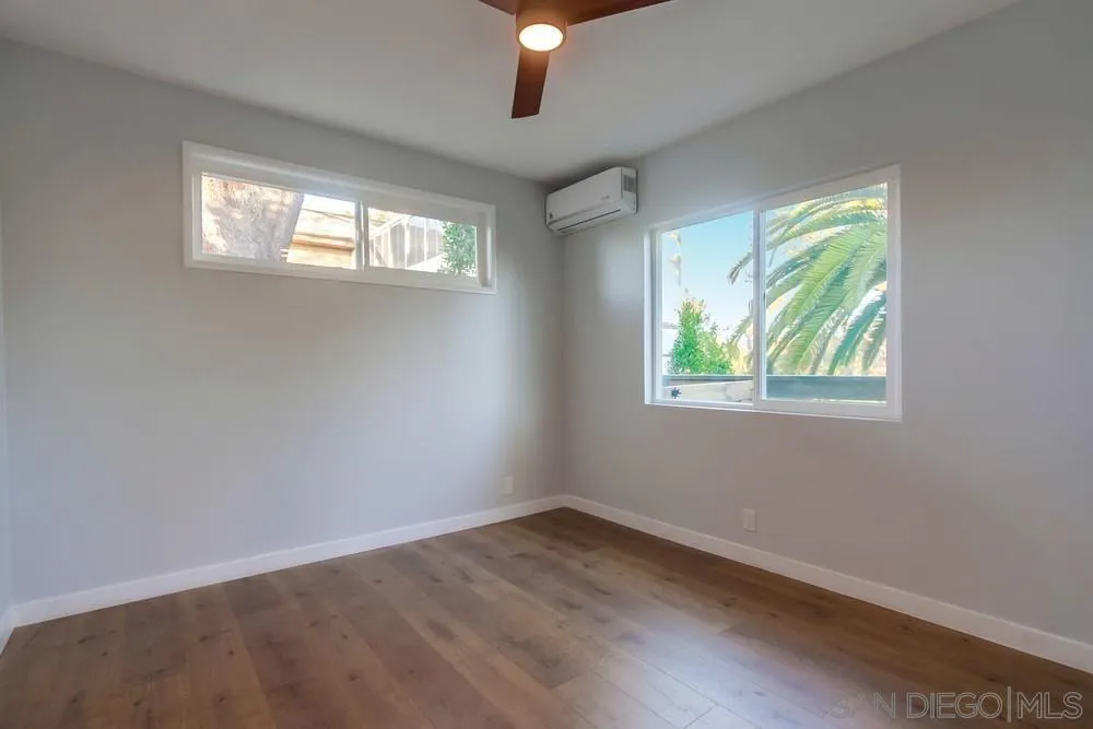 545 Ocean View Avenue Encinitas, CA 92024 - Photo 58 of 75 a view of an empty room with wooden floor and a window