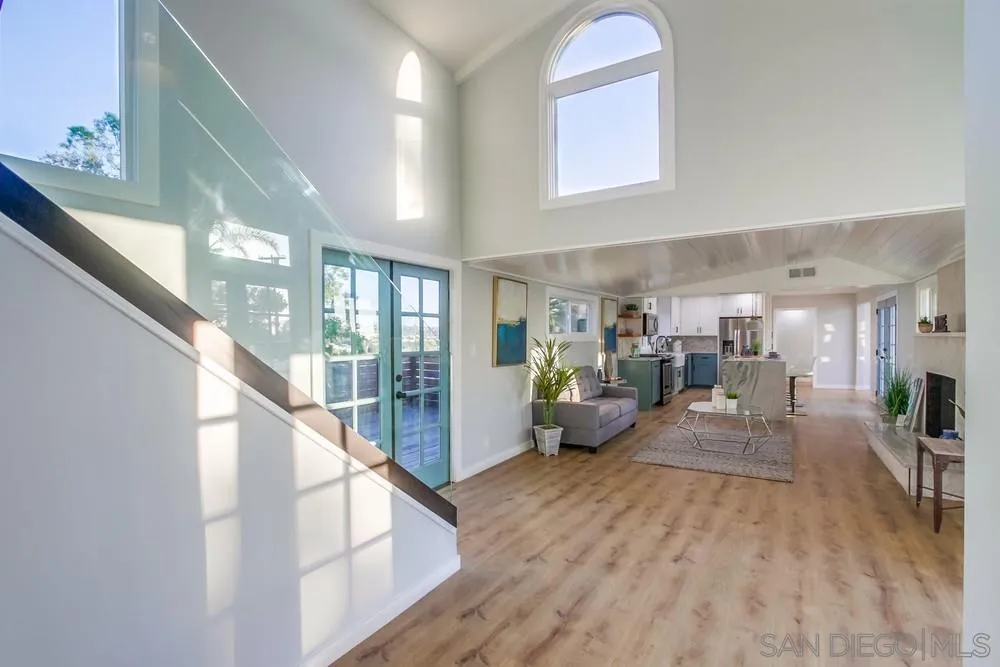 545 Ocean View Avenue Encinitas, CA 92024 - Photo 8 of 75 a view of a living room and kitchen with furniture wooden floor and windows
