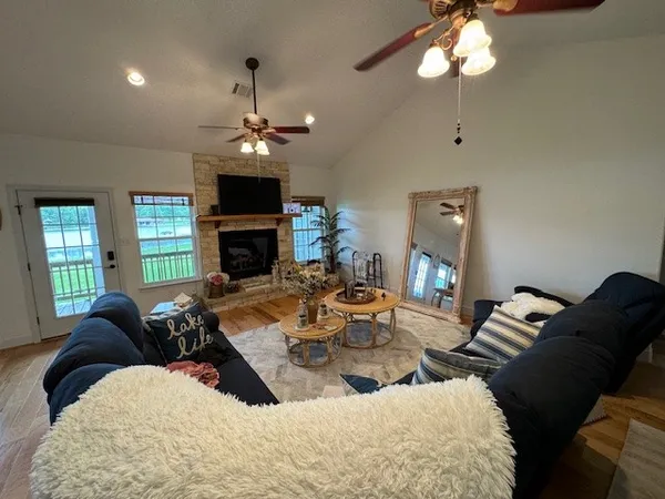 a living room with furniture fireplace and a window