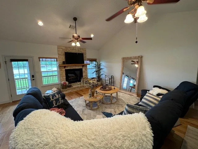 a living room with furniture fireplace and a window