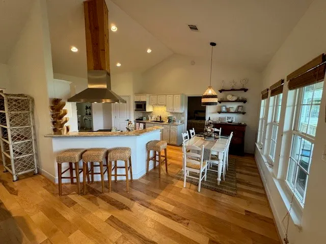 a view of a dining room with furniture and wooden floor