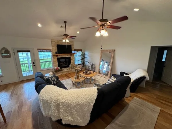 a living room with furniture a fireplace and a chandelier