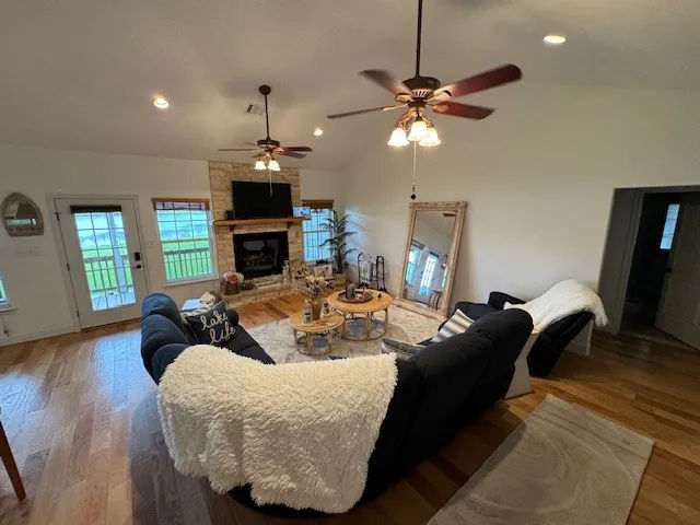 a living room with furniture a fireplace and a chandelier