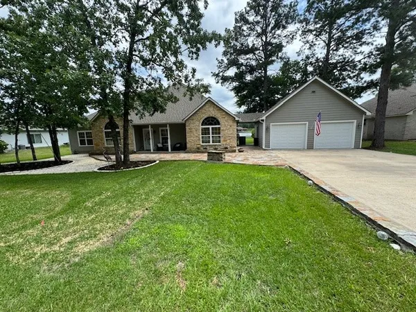 a front view of house with yard and green space