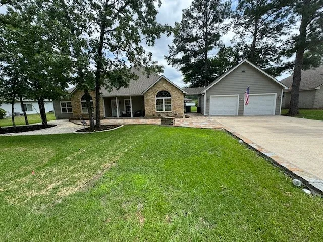 a front view of house with yard and green space