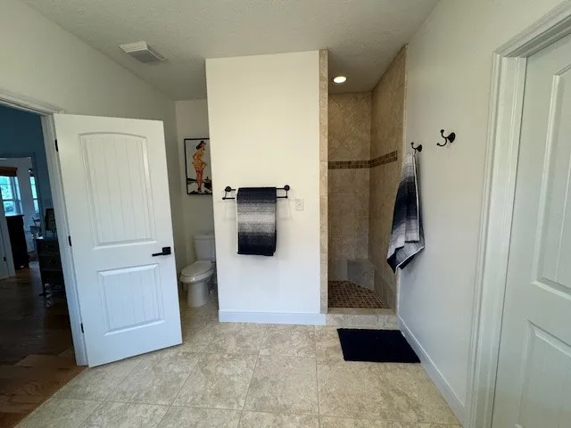 a bathroom with a shower and mirror
