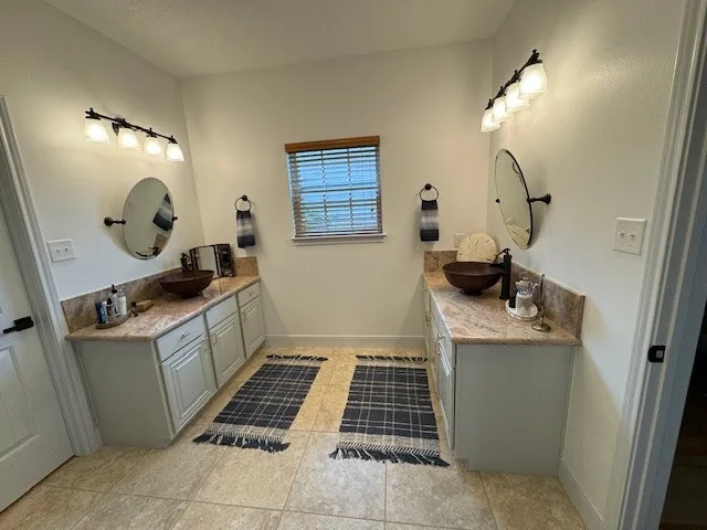 a room with a washing machine and a mirror