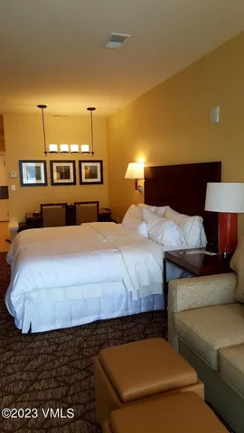 a bedroom with a bed and mirror