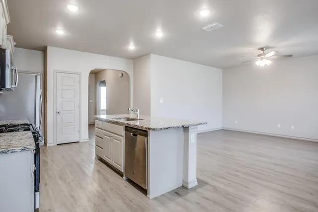 a kitchen with stainless steel appliances granite countertop a stove and a refrigerator