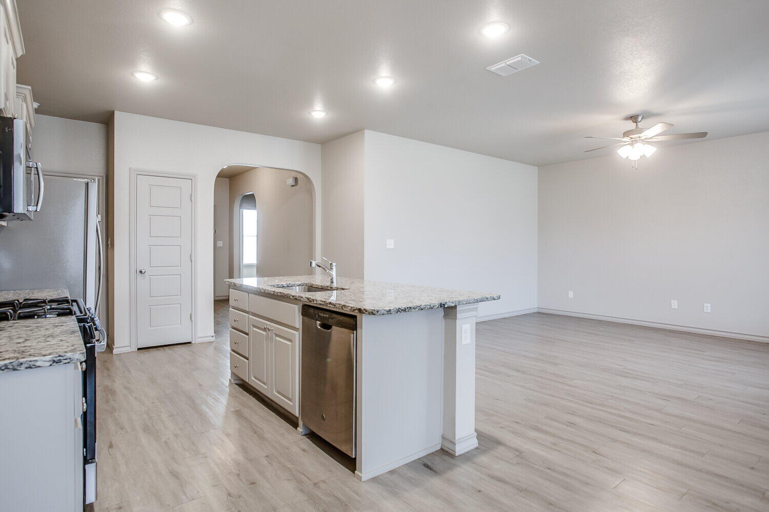 7518 88th Street Lubbock, TX 79424 - Photo 3 of 18 a kitchen with stainless steel appliances granite countertop a stove and a refrigerator
