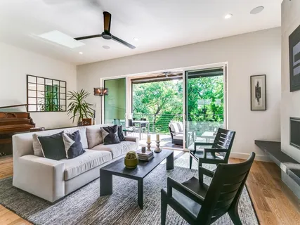 a living room with furniture and large windows