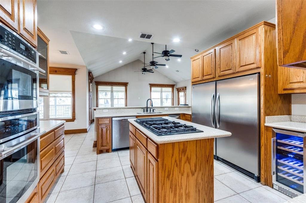 5520 Dido Hicks Road Fort Worth, TX 76179 - Photo 13 of 33 a kitchen with stainless steel appliances granite countertop a sink stove and refrigerator