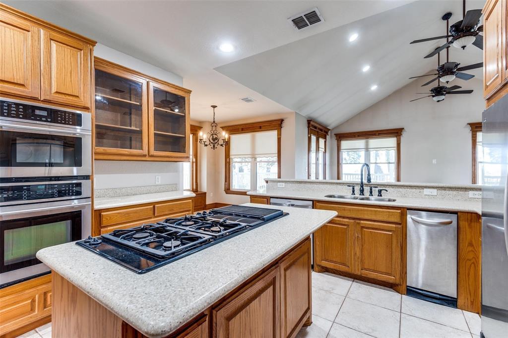 5520 Dido Hicks Road Fort Worth, TX 76179 - Photo 16 of 33 a kitchen with a stove a sink and a refrigerator