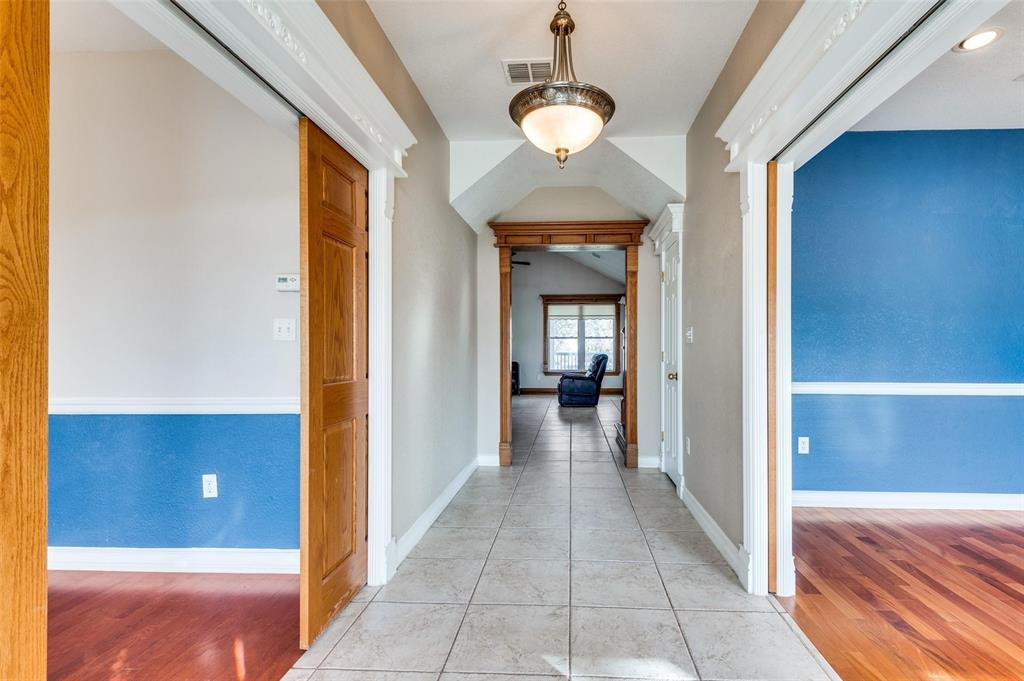 5520 Dido Hicks Road Fort Worth, TX 76179 - Photo 17 of 33 a view of a hallway with wooden floor and a large window