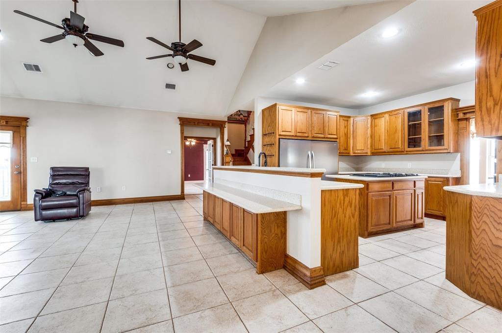 5520 Dido Hicks Road Fort Worth, TX 76179 - Photo 10 of 33 a kitchen with stainless steel appliances granite countertop a stove a sink and a refrigerator