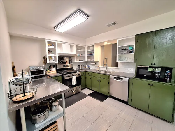 a kitchen with a sink stove and microwave