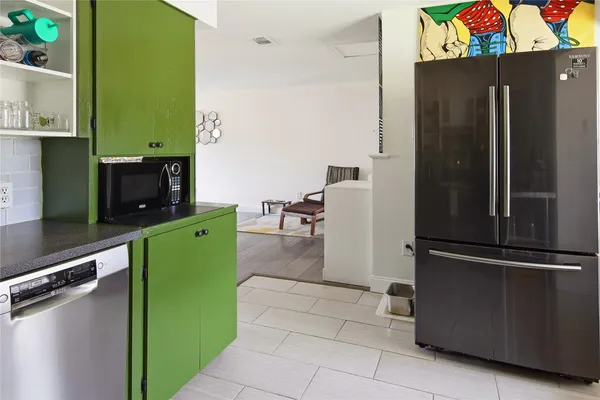 a kitchen with a refrigerator and a refrigerator