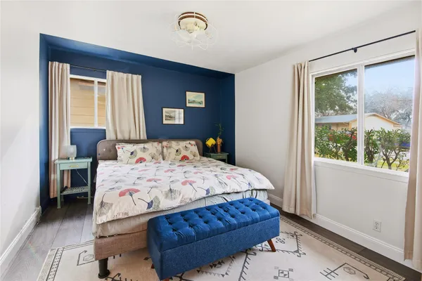 a bedroom with a bed table and a window