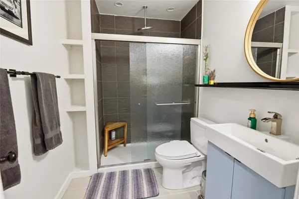 a bathroom with a sink toilet and shower