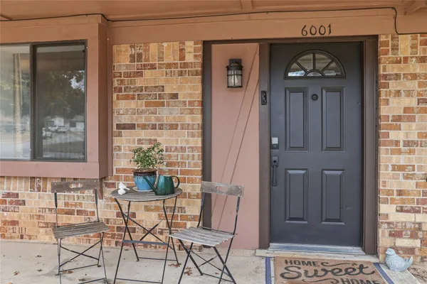 a view of a hallway with a door and a mirror