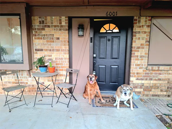 a living room filled with furniture and chandelier