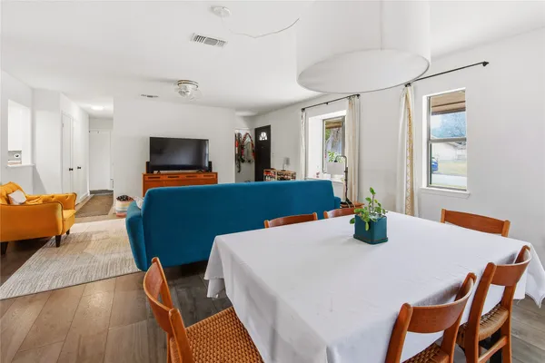 a view of a dining room with furniture and wooden floor