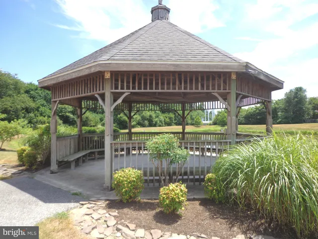 a view of a lake with couches chairs and city view
