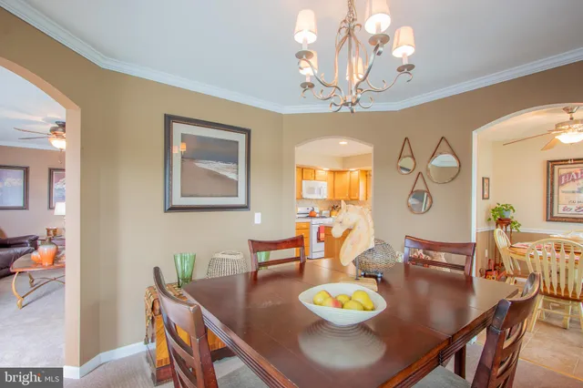 a view of a dining room with furniture and chandelier