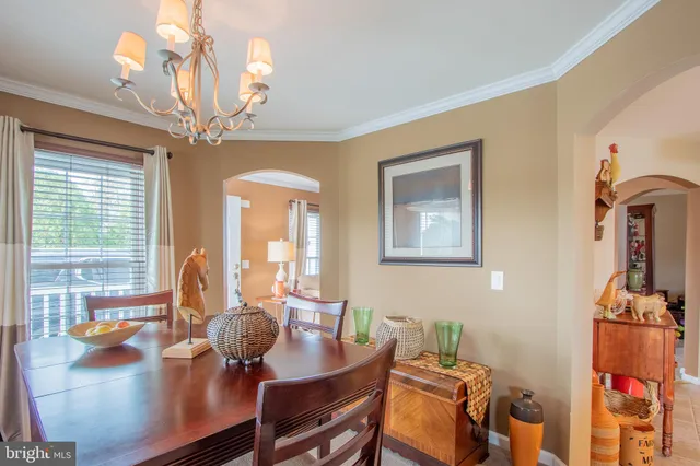 a view of a dining room with furniture wooden floor and chandelier