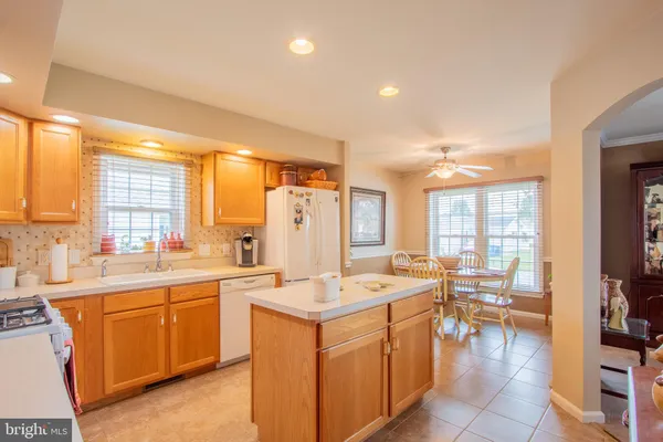 a kitchen with a sink a refrigerator and window