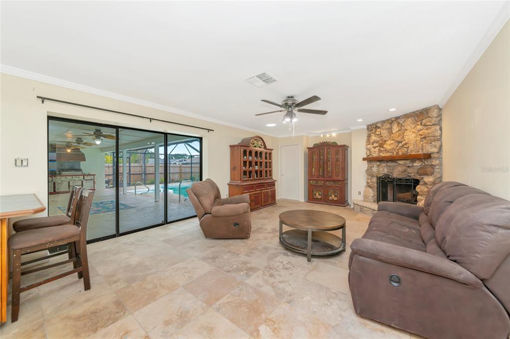 4656 Alexander Pope Lane Sarasota, FL 34241 - Photo 12 of 42 a living room with furniture and a fireplace
