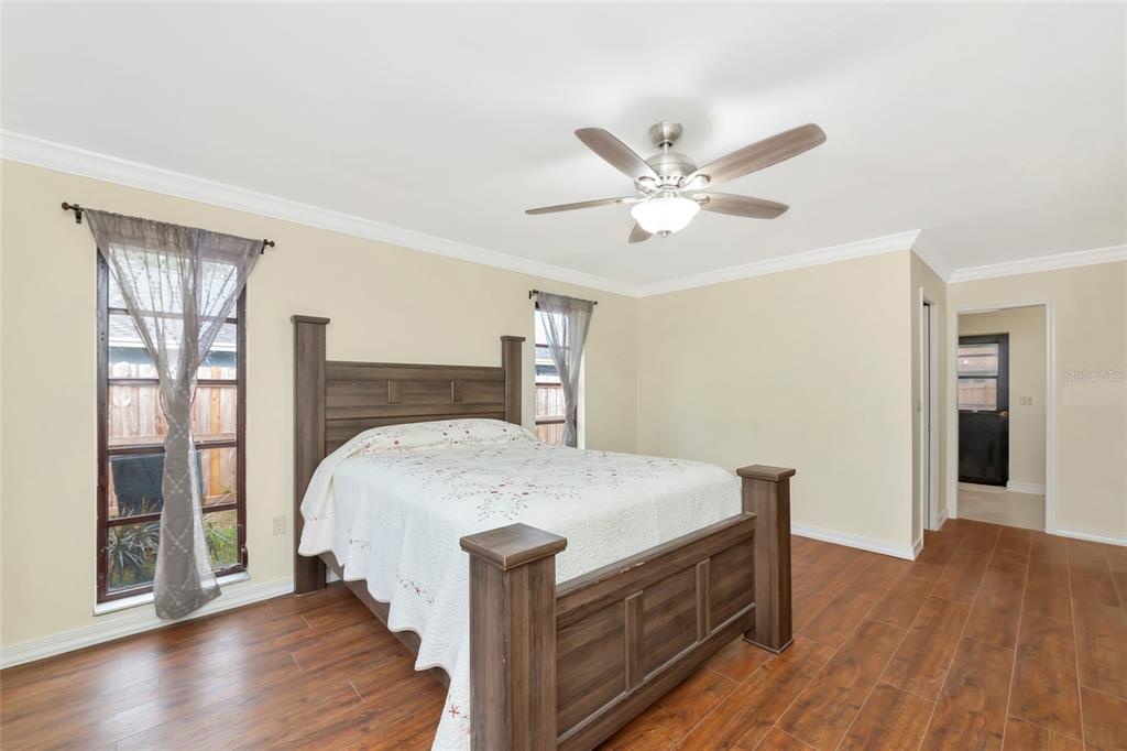 4656 Alexander Pope Lane Sarasota, FL 34241 - Photo 17 of 42 a bed sitting in a spacious bedroom next to a window