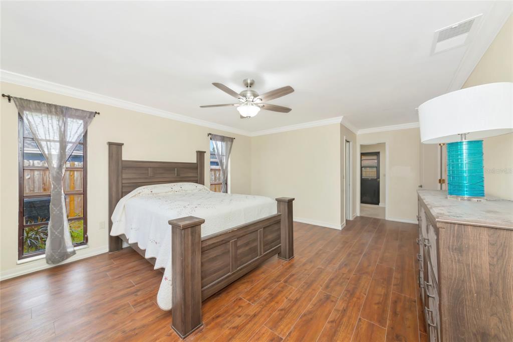 4656 Alexander Pope Lane Sarasota, FL 34241 - Photo 18 of 42 a bed room with a bed and a ceiling fan