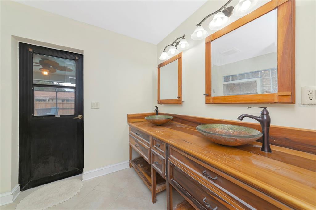 4656 Alexander Pope Lane Sarasota, FL 34241 - Photo 20 of 42 a bathroom with a granite countertop sink and a mirror