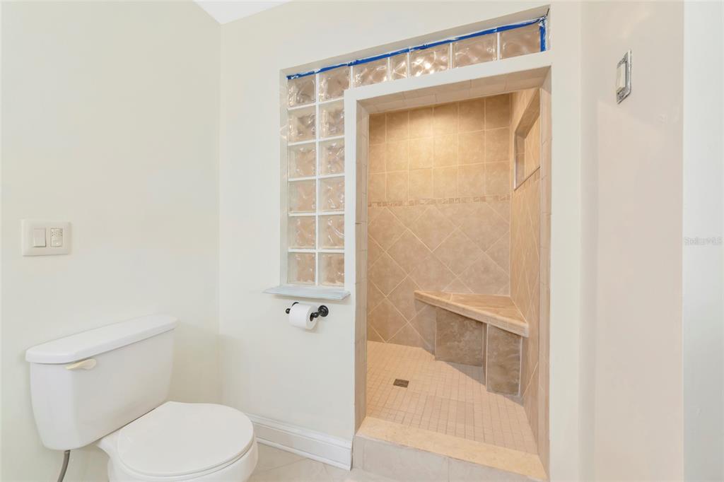4656 Alexander Pope Lane Sarasota, FL 34241 - Photo 21 of 42 a bathroom with a toilet and a shower