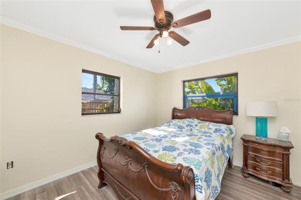 4656 Alexander Pope Lane Sarasota, FL 34241 - Photo 23 of 42 a bedroom with a bed and a dresser