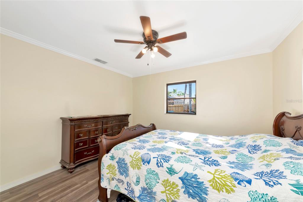 4656 Alexander Pope Lane Sarasota, FL 34241 - Photo 24 of 42 a bedroom with a bed and wooden floor