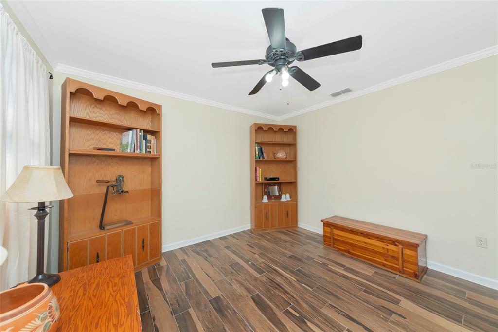 4656 Alexander Pope Lane Sarasota, FL 34241 - Photo 29 of 42 a bedroom with a bed and a chandelier