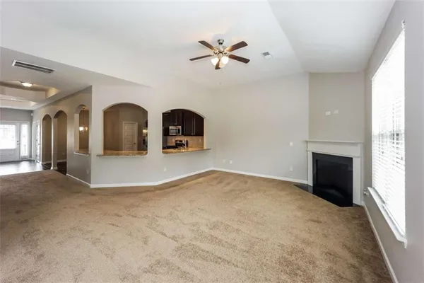 a view of a livingroom with a ceiling fan and window
