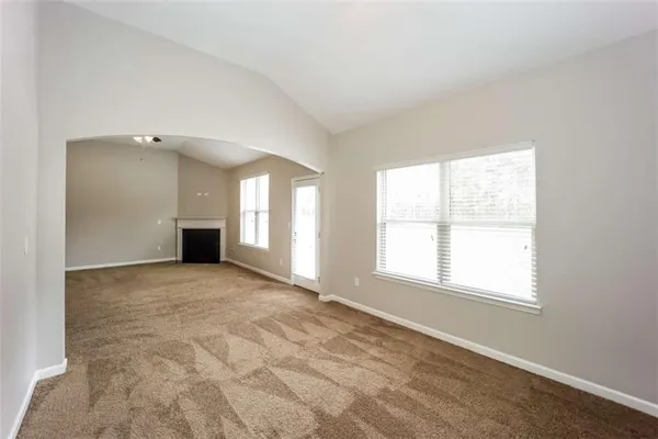 an empty room with a empty space and windows