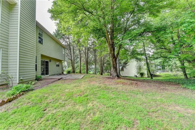 a view of a yard with a house and large tree