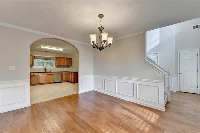 a view of a kitchen with cabinet and a hallway